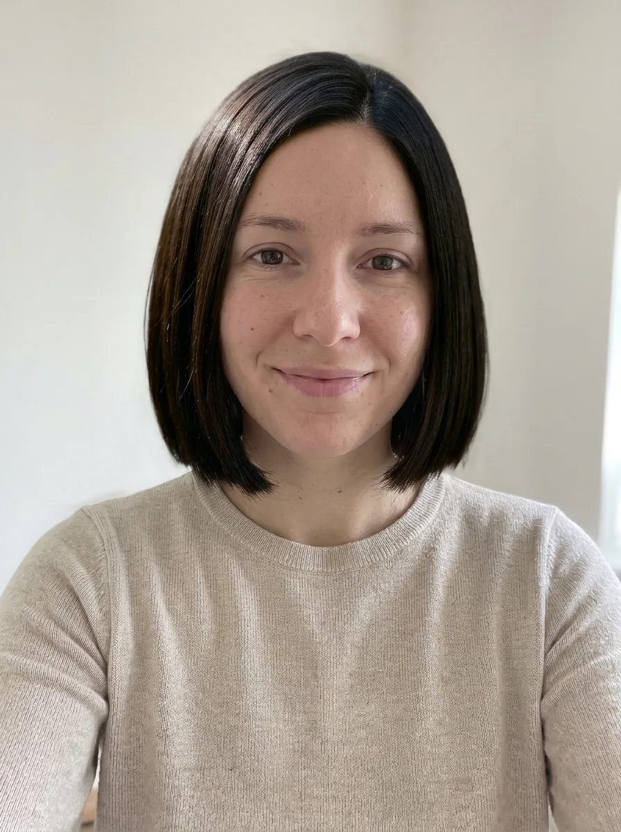 The same woman with a sleek chin-length bob and a side part